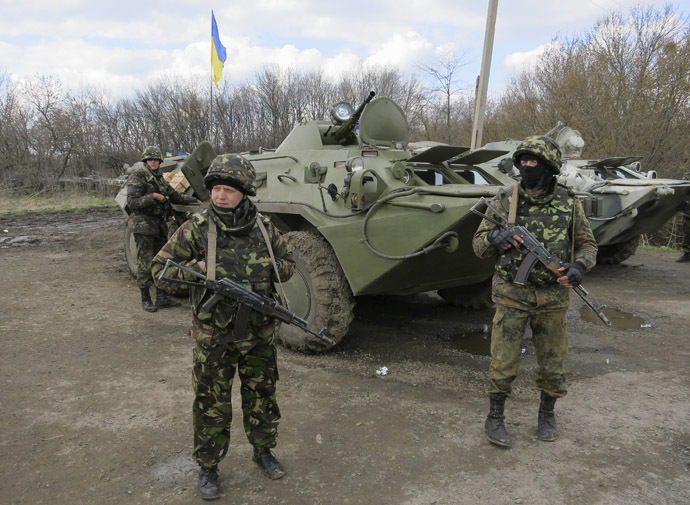 Ukrainian soldiers are seen near armored personnel carriers at a checkpoint near the town of Izium